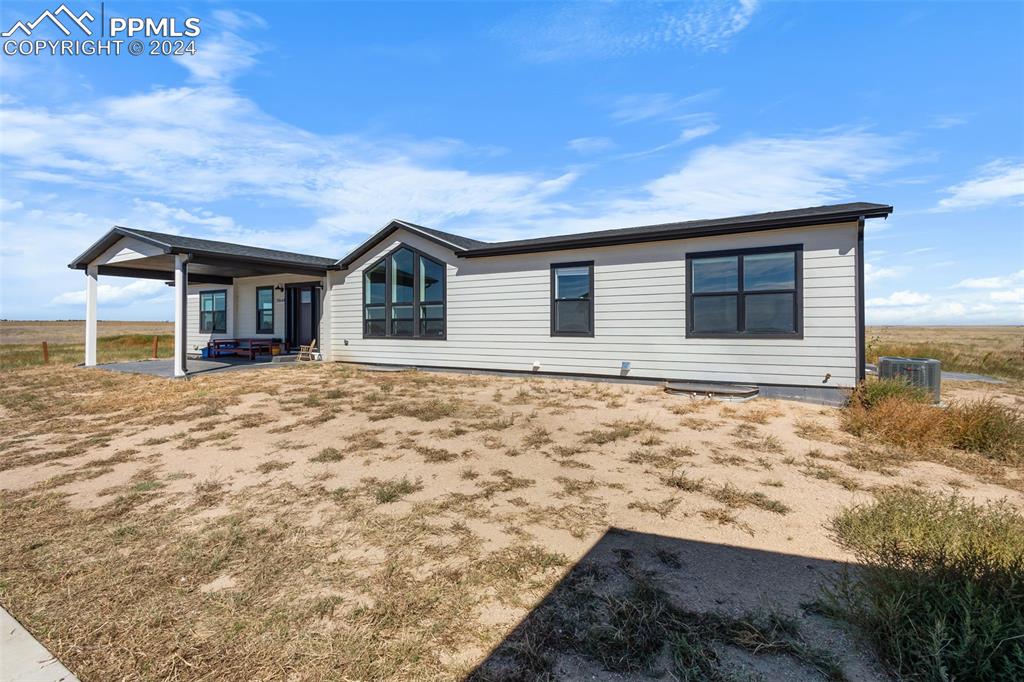 38640 Jones Road Rush, CO 80833 - Photo 39 of 41 a front view of a house with a yard and garage