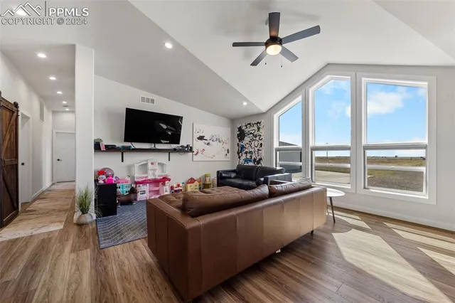 a living room with furniture and a large window