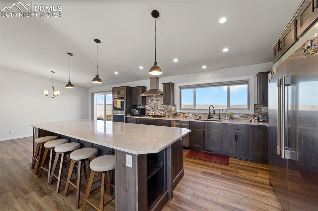 38640 Jones Road Rush, CO 80833 - Photo 7 of 41 a kitchen with stainless steel appliances granite countertop a kitchen island a stove a table and chairs