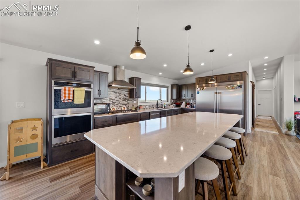38640 Jones Road Rush, CO 80833 - Photo 8 of 41 a large kitchen with stainless steel appliances a large center island attached withe living room