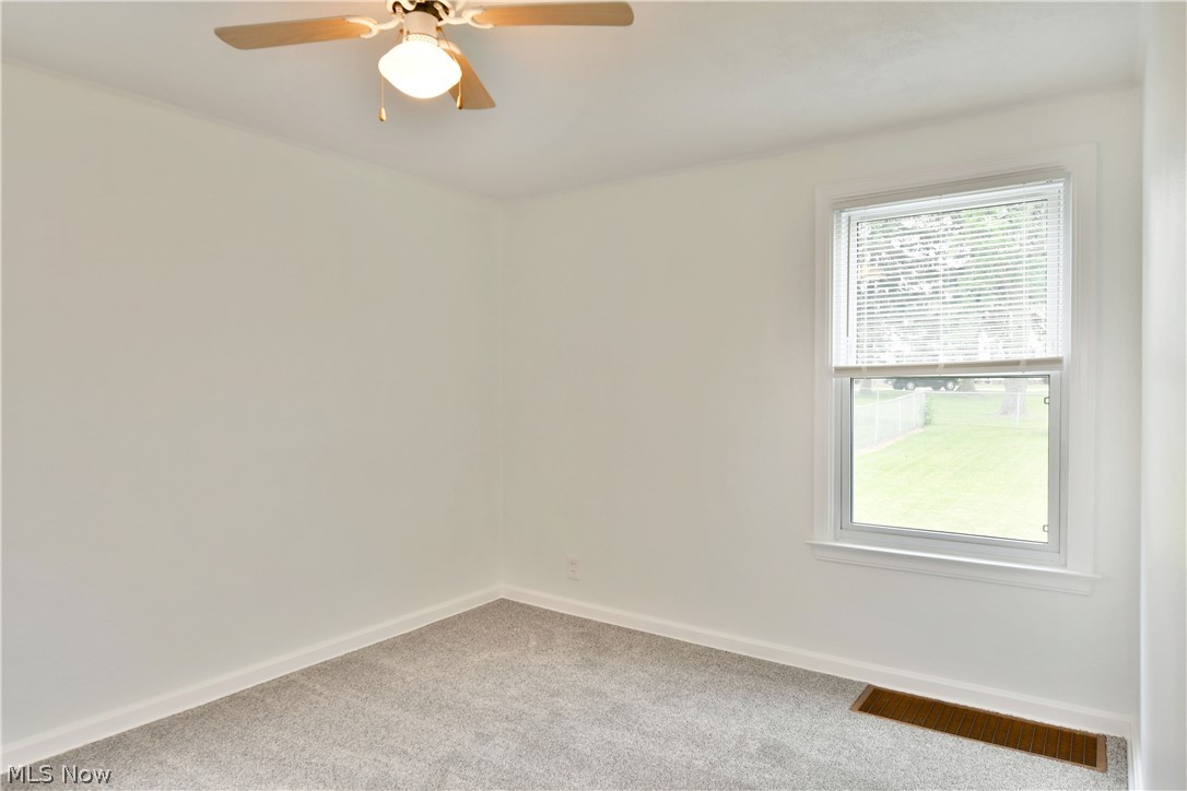 130 State Road Northwest Warren, OH 44483 - Photo 17 of 35 Carpeted spare room featuring ceiling fan