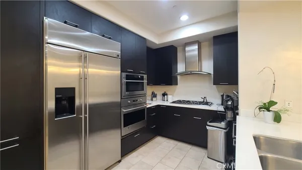 a kitchen with a sink stainless steel appliances and cabinets