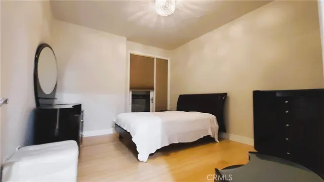 a bedroom with a bed and dresser