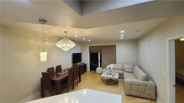 a living room with furniture and a chandelier