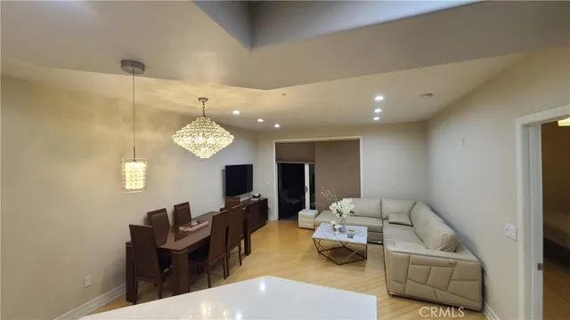 a living room with furniture and a chandelier