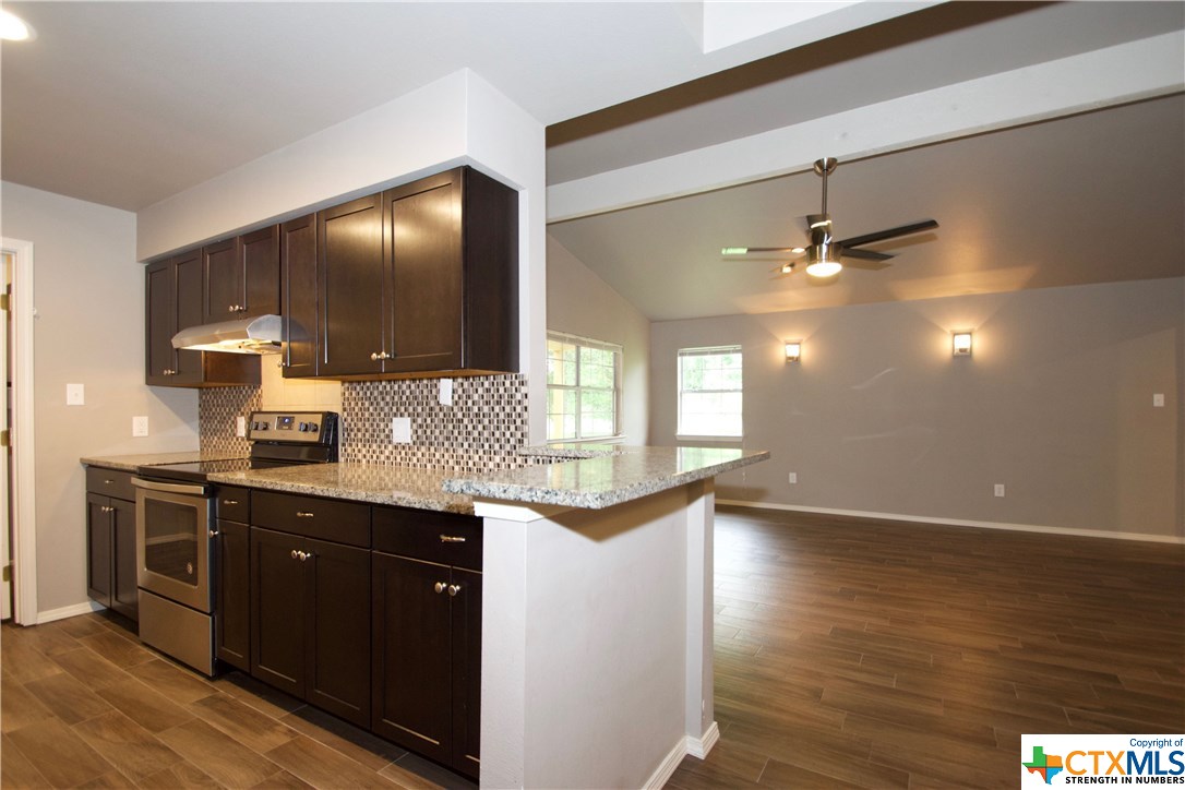 100 Riverside Drive San Marcos, TX 78666 - Photo 1 of 1 a kitchen with stainless steel appliances granite countertop a sink and a stove