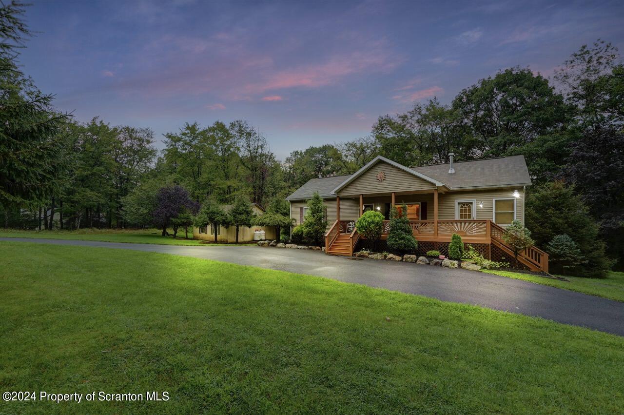 425 Devils Hole Road Cresco, PA 18326 - Photo 4 of 55 a front view of a house with yard and green space