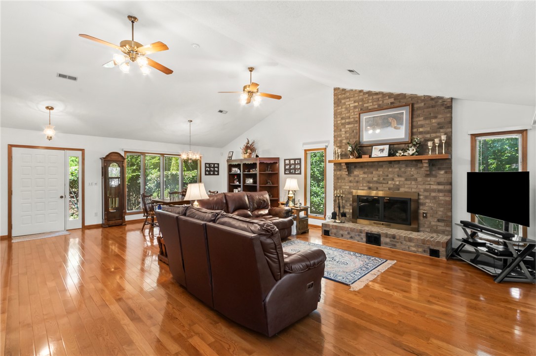 202 Plantation Point Anderson, SC 29625 - Photo 10 of 48 A spacious common area with a striking brick fireplace and warm hardwood floors awaits.