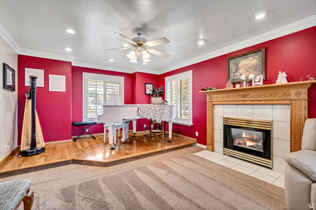 1697 North 500 West Mapleton, UT 84664 - Photo 7 of 50 Living room with healthy amount of natural light, a fireplace, ceiling fan, crown molding, and recessed lighting