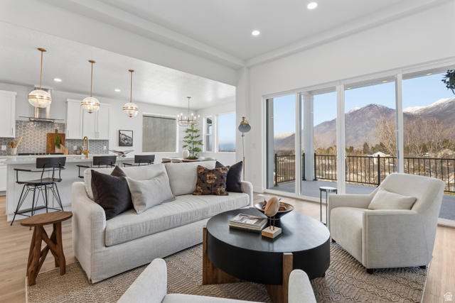 624 North Legend Circle, Unit 480 Mapleton, UT 84664 - Photo 14 of 34 Living area with light wood-style flooring, a mountain view, and a chandelier