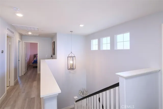 a view of hallway with furniture and wooden floor