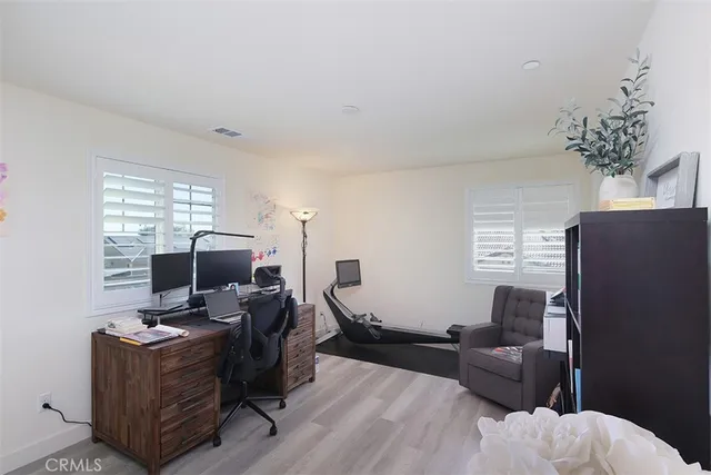 a view of a workspace with furniture and a window