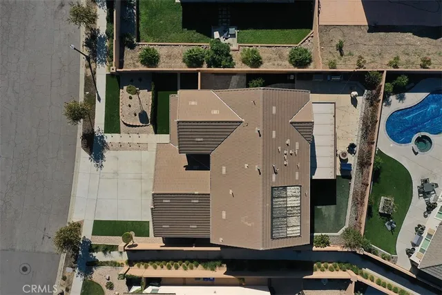 an aerial view of a residential houses with outdoor space and street view