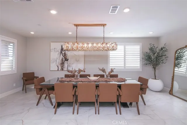 a view of a dining room with furniture and window
