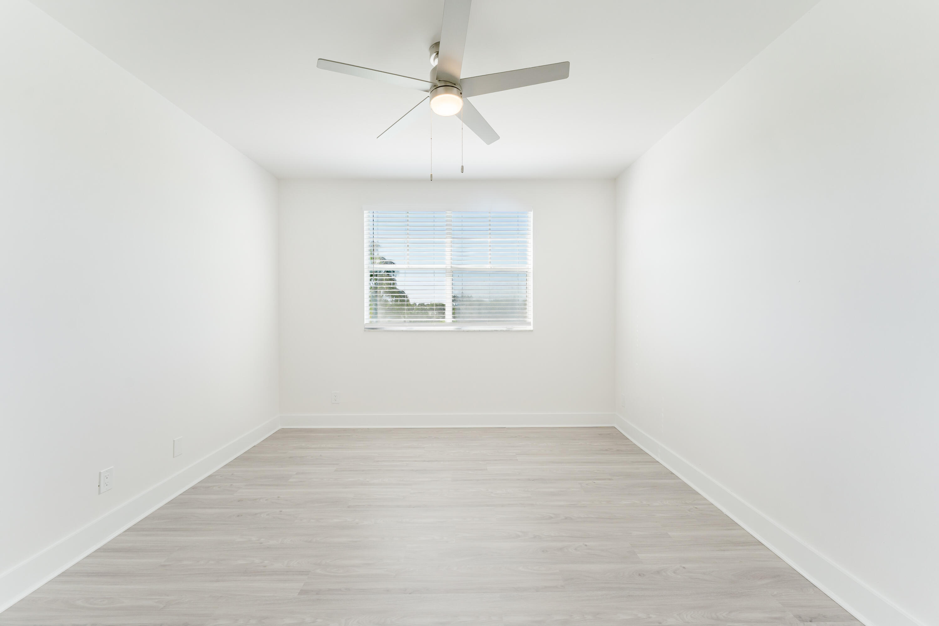 20889 St Andrews Boulevard Boca Raton, FL 33433 - Photo 17 of 46 an empty room with a window and ceiling fan