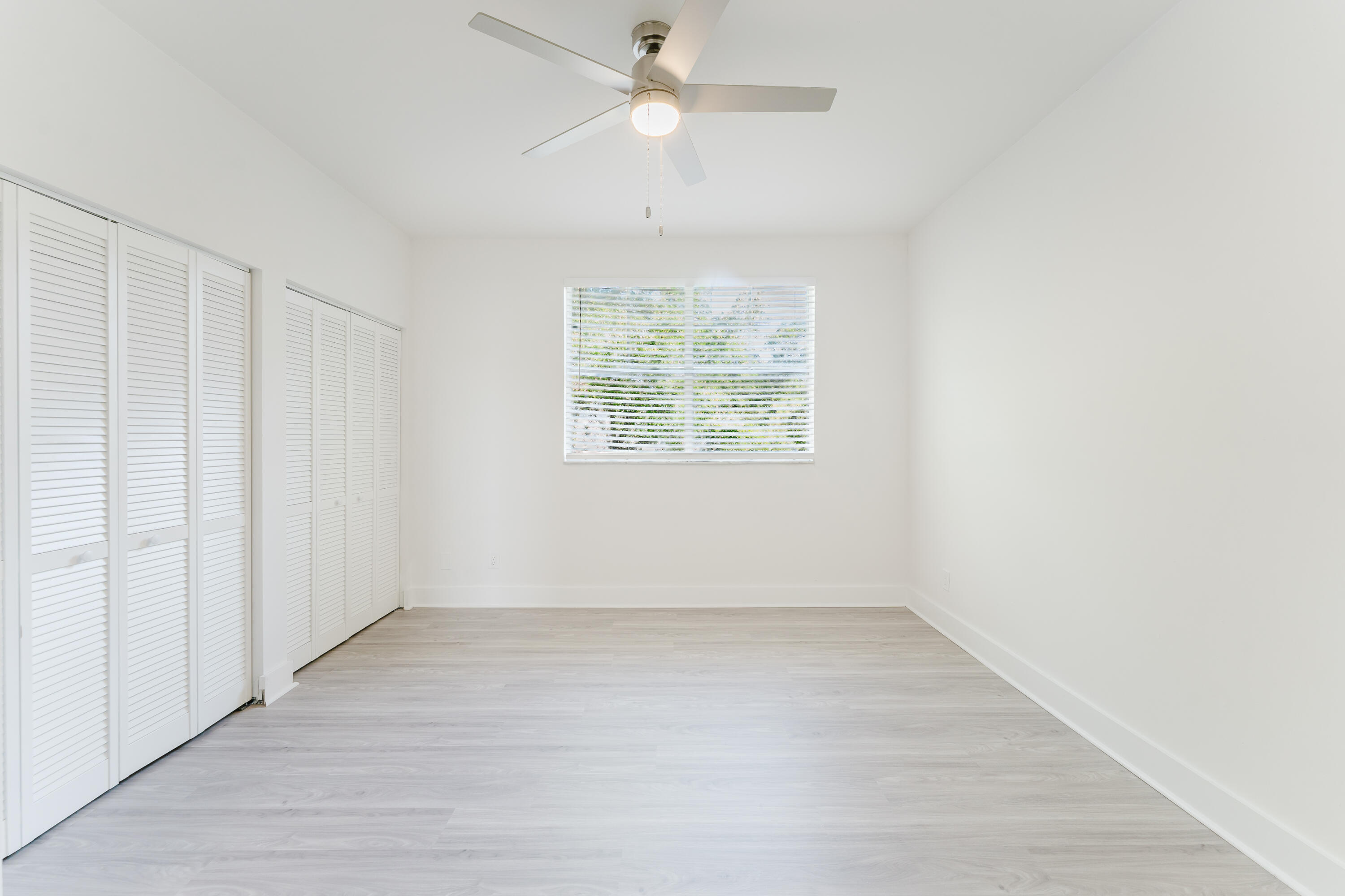 20889 St Andrews Boulevard Boca Raton, FL 33433 - Photo 28 of 46 wooden floor in an empty room with a window