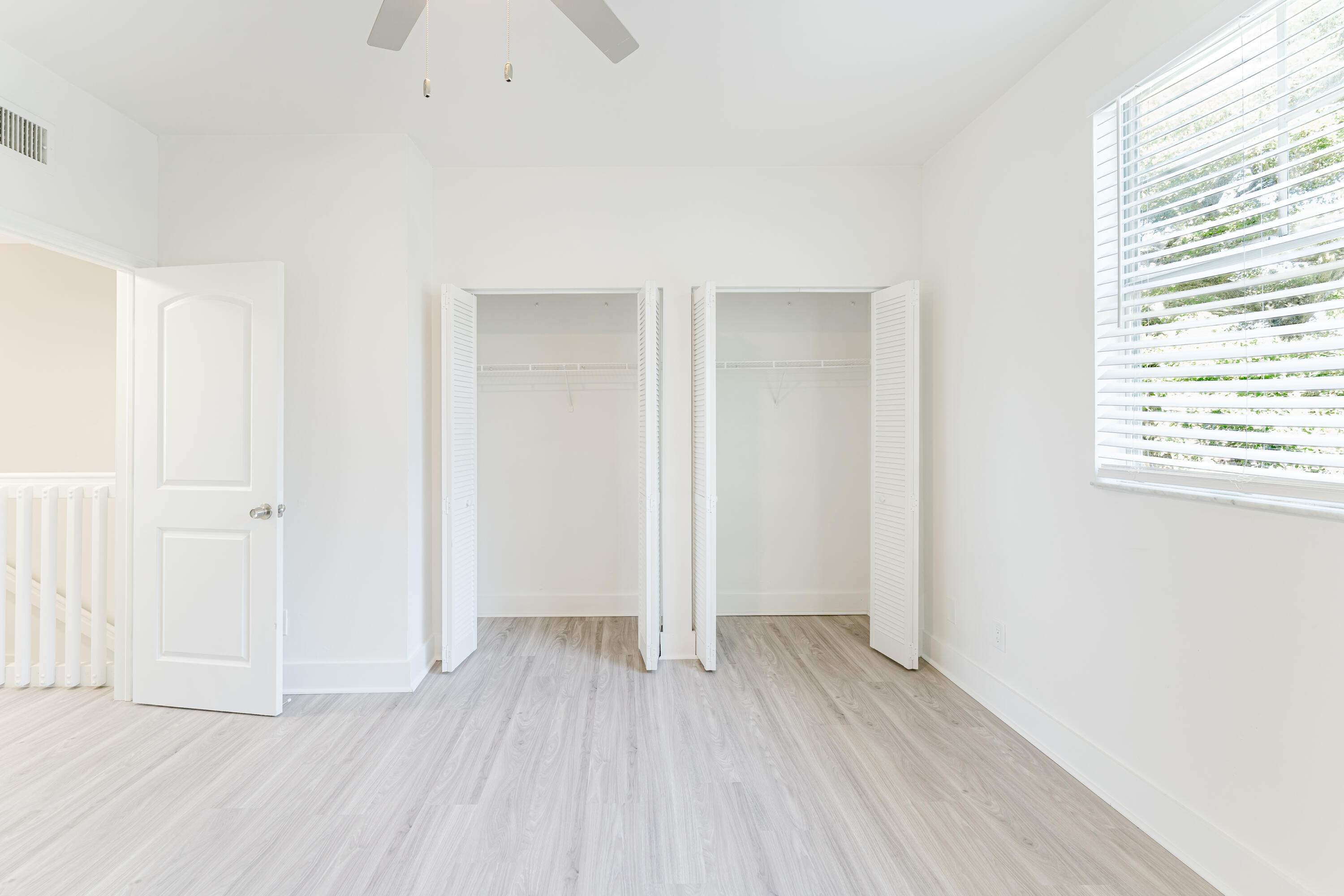 20889 St Andrews Boulevard Boca Raton, FL 33433 - Photo 32 of 46 an empty room with wooden floor and windows