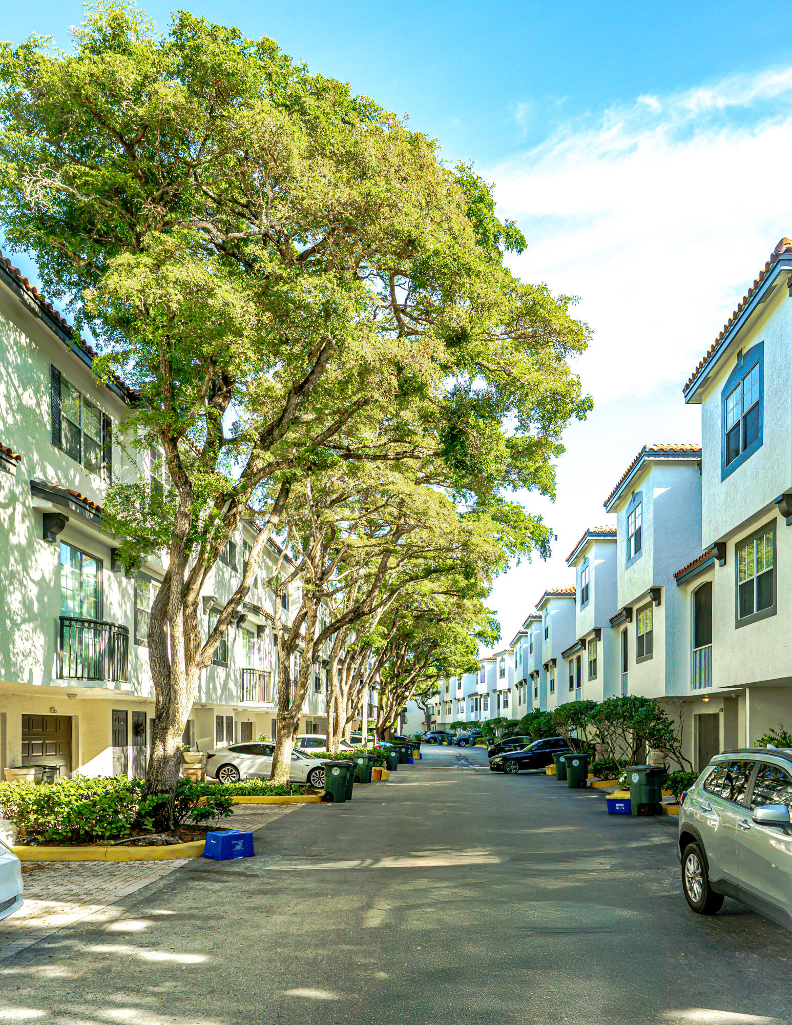 20889 St Andrews Boulevard Boca Raton, FL 33433 - Photo 36 of 46 a city street lined with buildings and cars