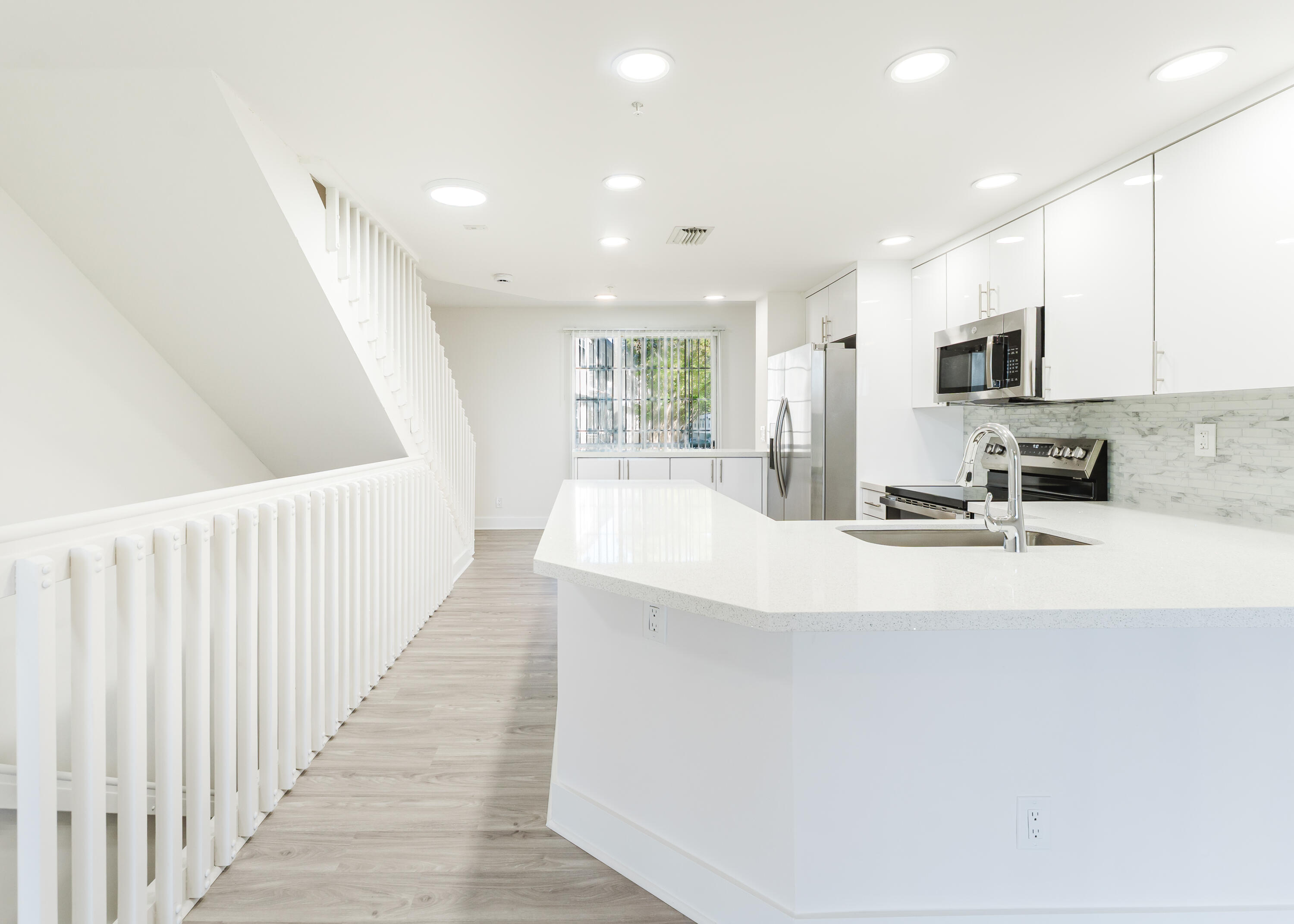 20889 St Andrews Boulevard Boca Raton, FL 33433 - Photo 5 of 46 a view of a kitchen with kitchen island granite countertop a sink and dishwasher stove top oven with wooden floor
