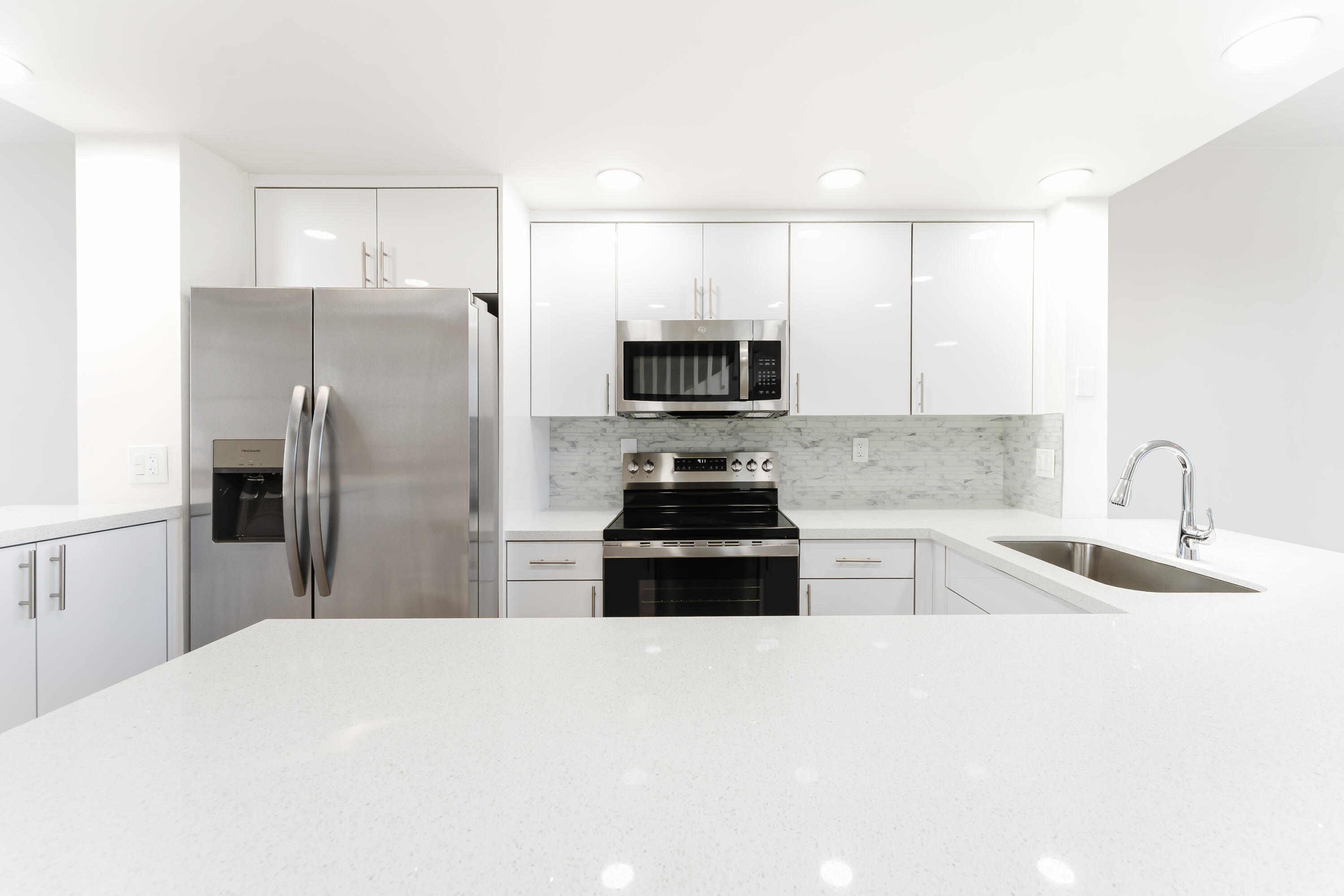 20889 St Andrews Boulevard Boca Raton, FL 33433 - Photo 7 of 46 a kitchen with a refrigerator sink and microwave