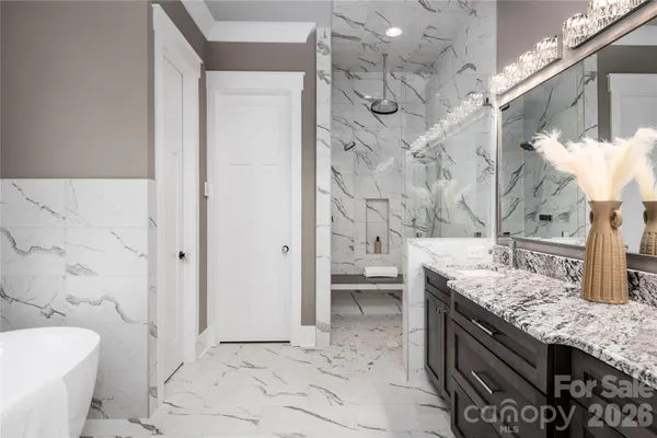 a spacious bathroom with a granite countertop sink a toilet and shower