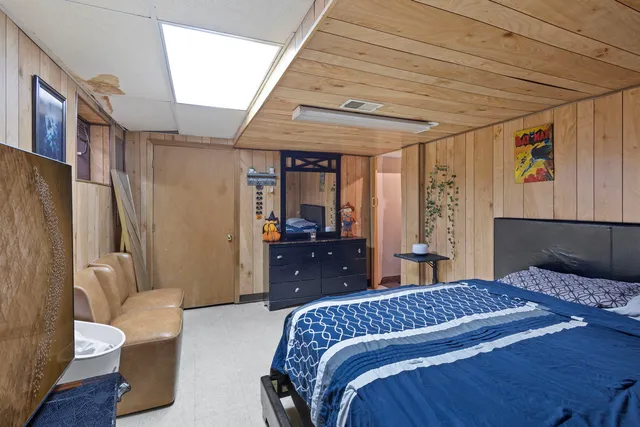 a bedroom with a bed and a large window