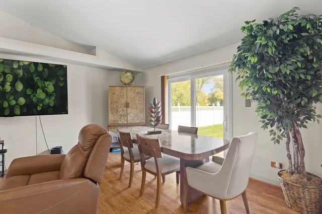 a living room with furniture a table and a large window