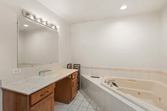 a bathroom with a sink a vanity and a bathtub