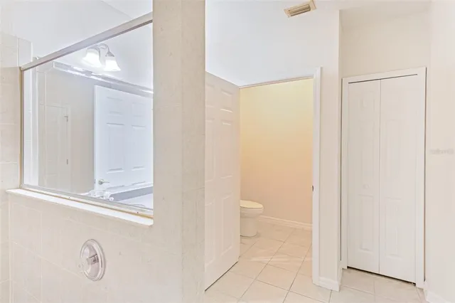 a bathroom with a toilet a sink and a mirror