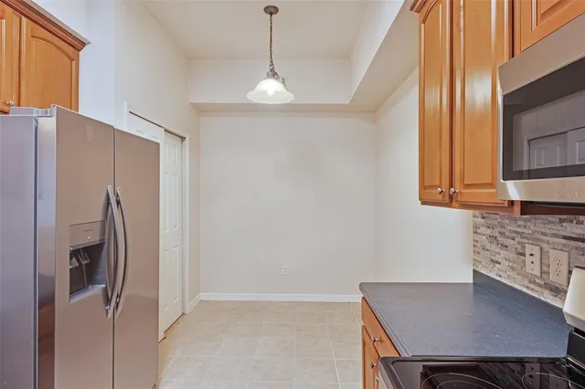 a kitchen with stainless steel appliances a refrigerator and a stove