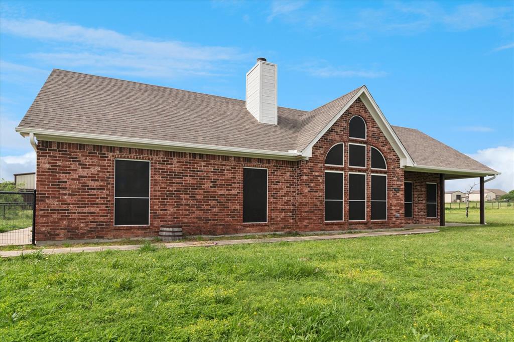 6005 Hawkeye Road Krum, TX 76249 - Photo 2 of 27 Brick exterior featuring a prominent arched window arrangement and a covered side porch