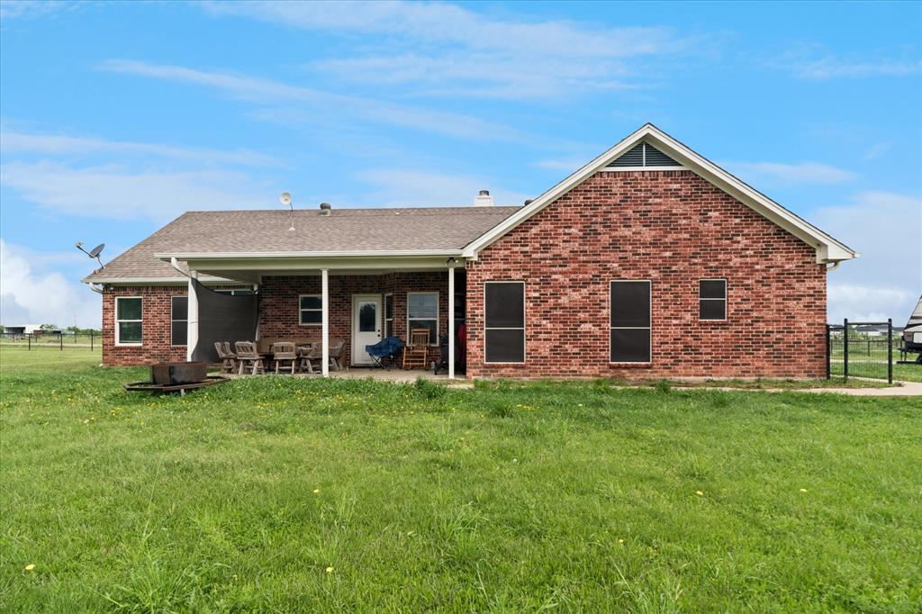 6005 Hawkeye Road Krum, TX 76249 - Photo 23 of 27 Brick exterior with a gabled roofline and covered patio