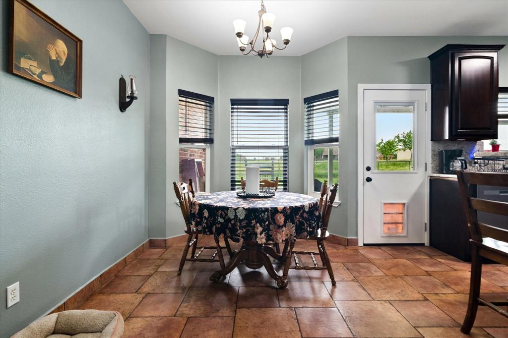 6005 Hawkeye Road Krum, TX 76249 - Photo 5 of 27 Dining area with tile flooring and a bay window