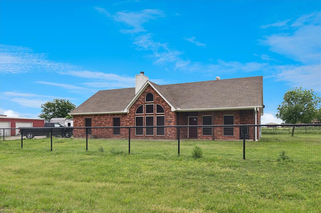 6005 Hawkeye Road Krum, TX 76249 - Photo 7 of 27 Brick exterior residence featuring a prominent arched window arrangement and a gabled roofline