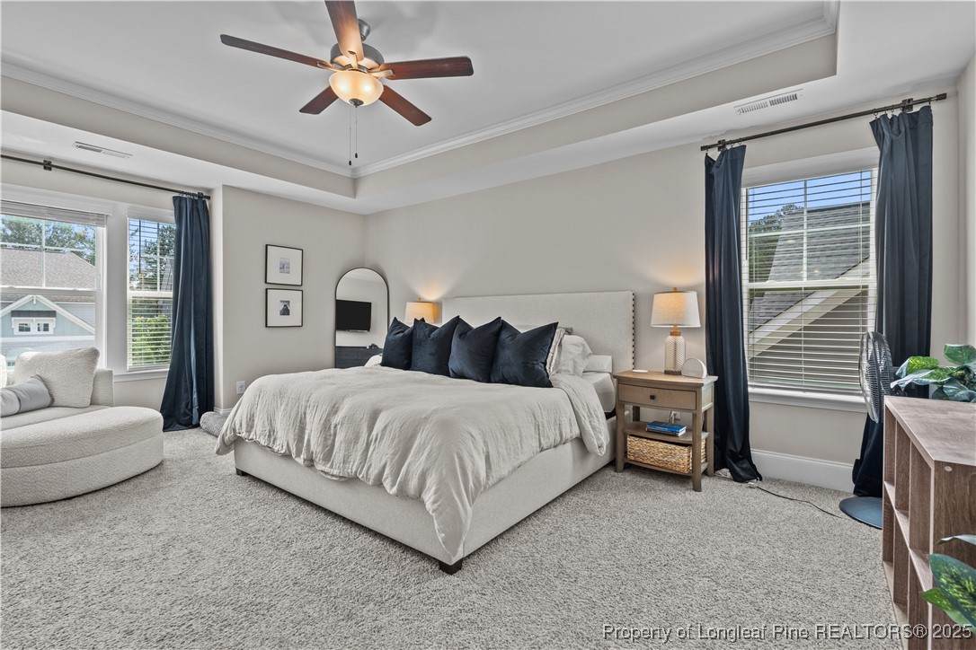 479 Kerr Lake Road Aberdeen, NC 28315 - Photo 16 of 43 a spacious bedroom with a bed a chandelier and a couch
