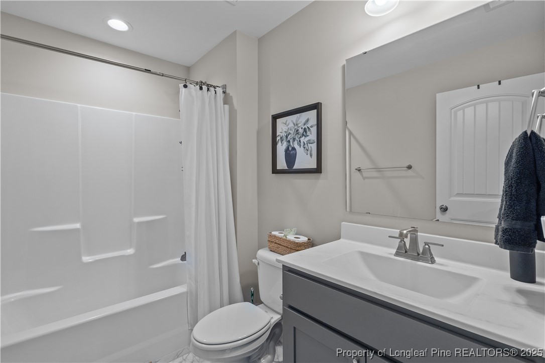 479 Kerr Lake Road Aberdeen, NC 28315 - Photo 23 of 43 a bathroom with a sink a toilet and shower