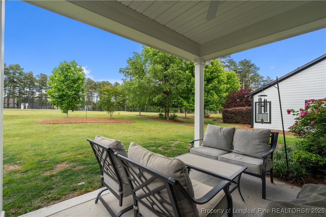479 Kerr Lake Road Aberdeen, NC 28315 - Photo 28 of 43 a view of a chairs and table in patio with a yard