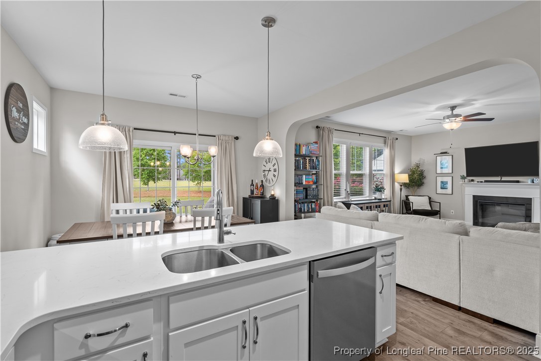 479 Kerr Lake Road Aberdeen, NC 28315 - Photo 10 of 43 a view of a kitchen with a sink a window and chairs
