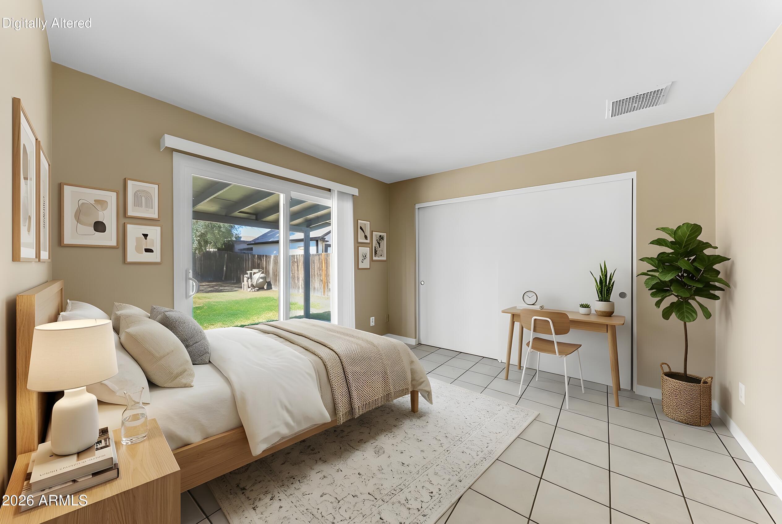 4723 East Vineyard Road Phoenix, AZ 85042 - Photo 16 of 27 a bedroom with a large bed and a potted plant