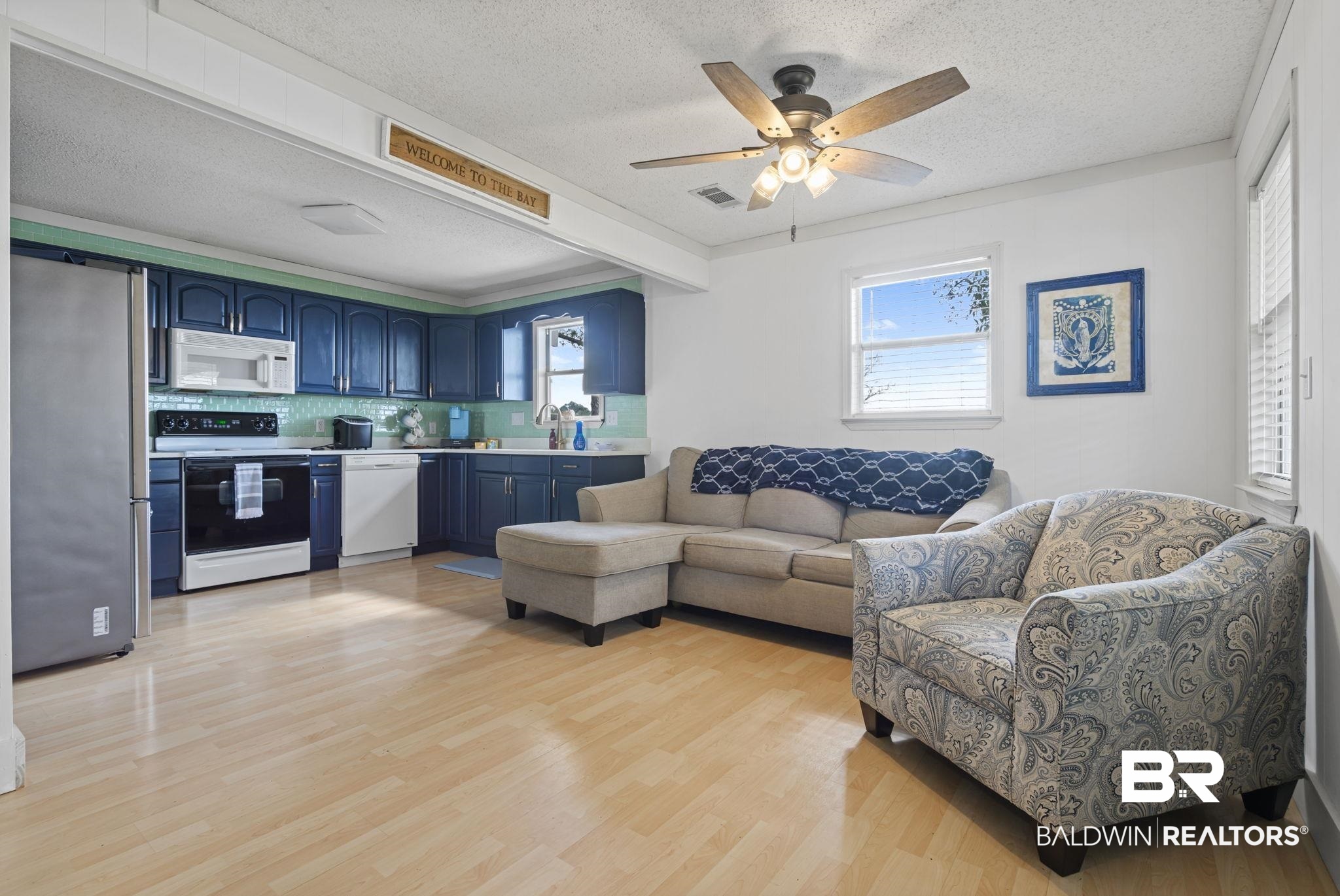 7947 Bayshore Drive Elberta, AL 36530 - Photo 12 of 26 Living area with a textured ceiling, ceiling fan, and light wood-style floors