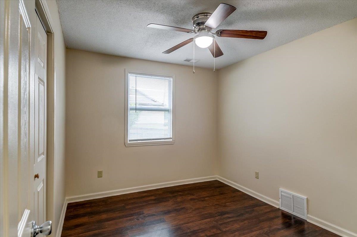 1411 Roberts Road Memphis, TN 38106 - Photo 12 of 24 Room featuring dark wood-finish flooring, light-toned walls, and white trim