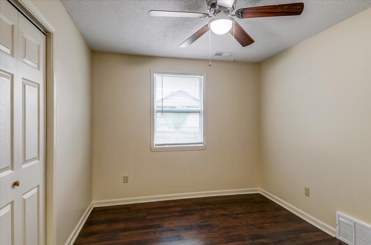 1411 Roberts Road Memphis, TN 38106 - Photo 13 of 24 Interior room featuring wood-finish flooring, a white window with horizontal blinds, and a ceiling fan with light fixture