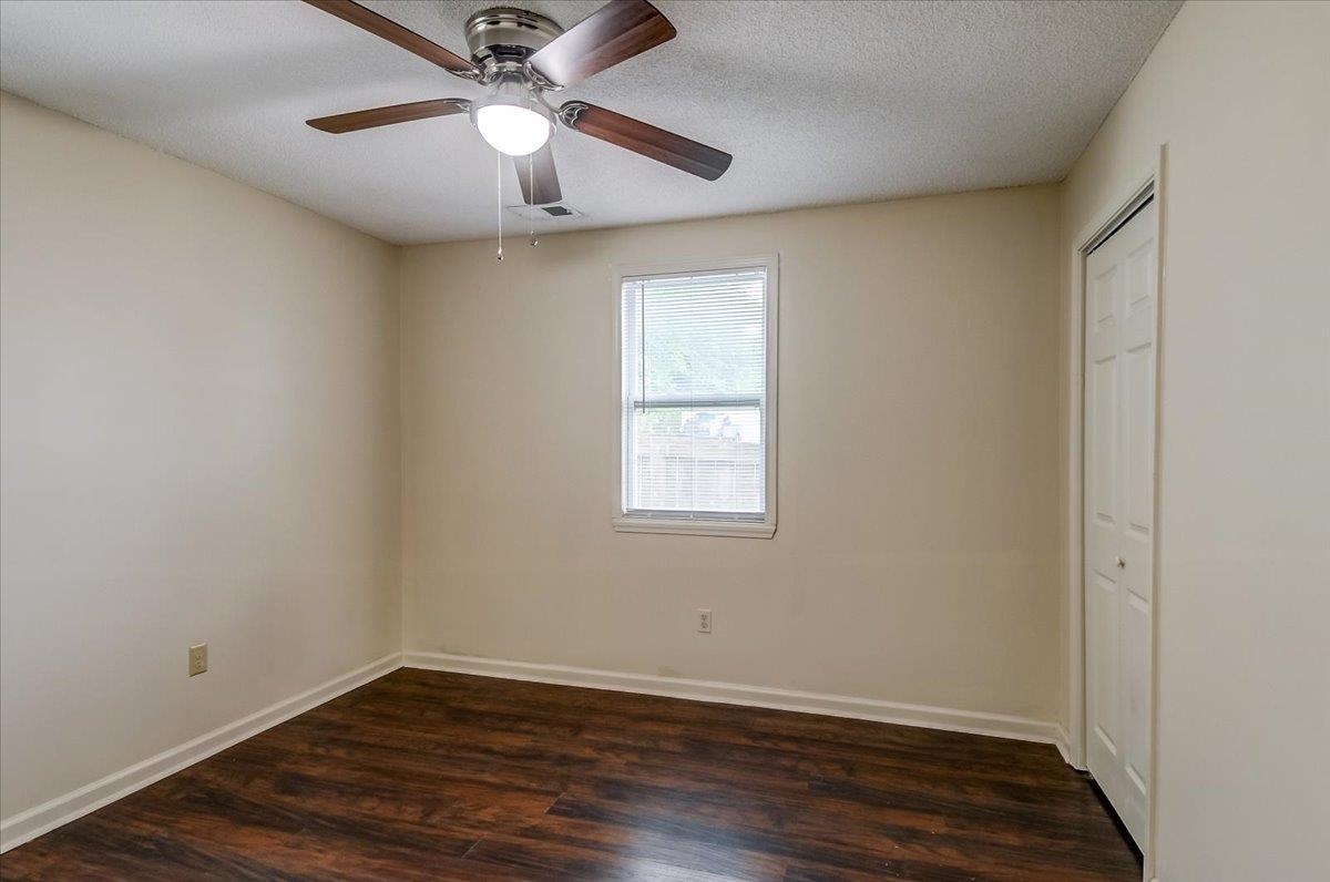 1411 Roberts Road Memphis, TN 38106 - Photo 14 of 24 Room featuring wood-finish flooring, neutral wall tones, and a ceiling fan with integrated lighting
