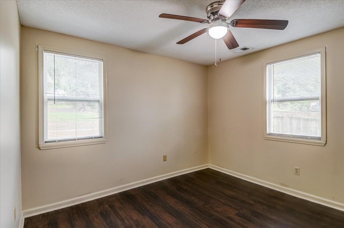 1411 Roberts Road Memphis, TN 38106 - Photo 17 of 24 Room featuring dark wood-finish flooring, light-toned walls, and a ceiling fan with integrated lighting