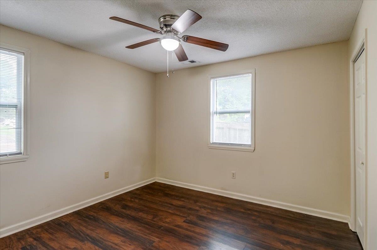 1411 Roberts Road Memphis, TN 38106 - Photo 18 of 24 Room featuring wood-finish flooring, light-toned walls, and a ceiling fan with integrated lighting