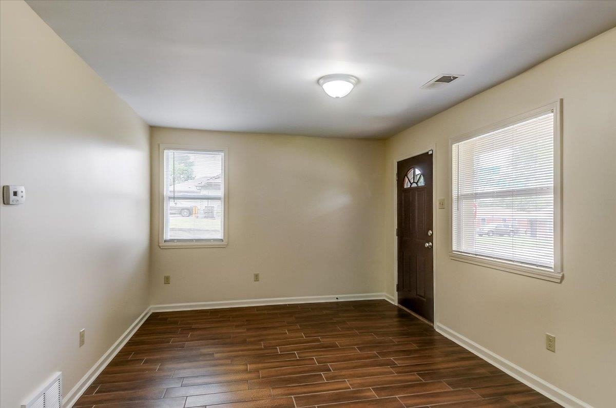 1411 Roberts Road Memphis, TN 38106 - Photo 5 of 24 Bright interior space featuring wood-finish flooring, light-toned walls, and white baseboards