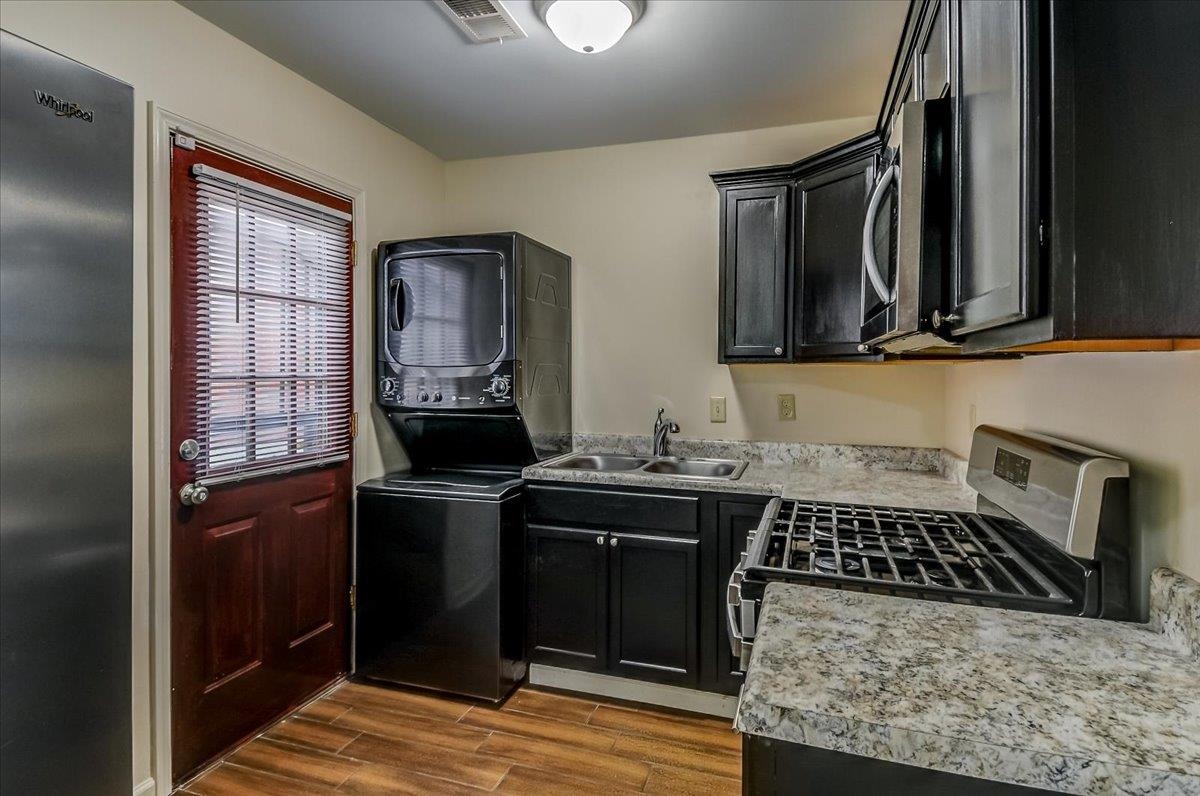 1411 Roberts Road Memphis, TN 38106 - Photo 10 of 24 Kitchen featuring black cabinetry, a stainless steel gas range, and speckled countertops
