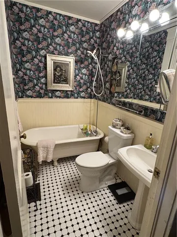 a bathroom with a toilet a sink and a mirror