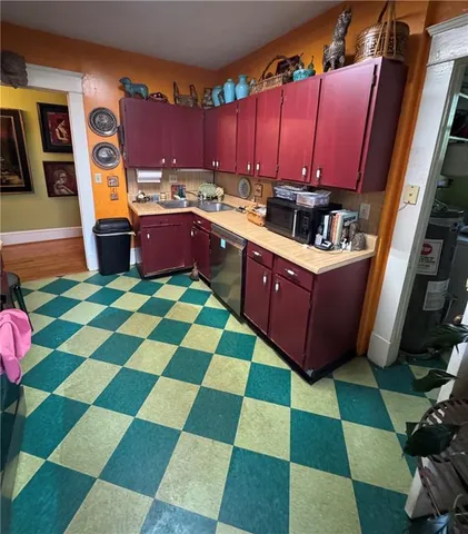 a kitchen with a sink cabinets and window