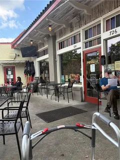 a view of a patio with table and chairs potted plants